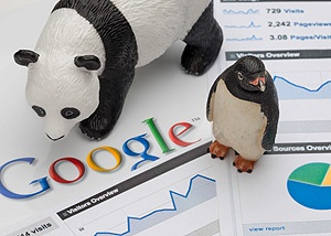 Toy panda and penguin standing on Google screenshots