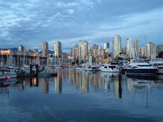 small city skyline in background with small marina in foreground