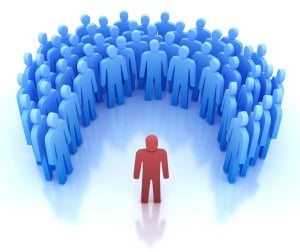 A single red figure facing a crowd of blue figures